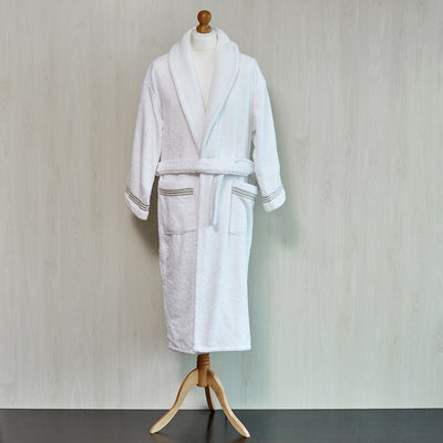 White Robe with Taupe embroidered trim on wooden form.