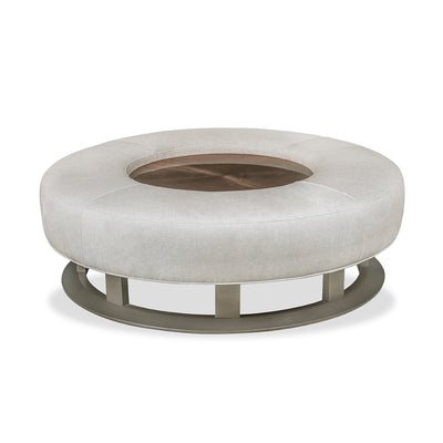 round leather ottoman with glass insert in middle.